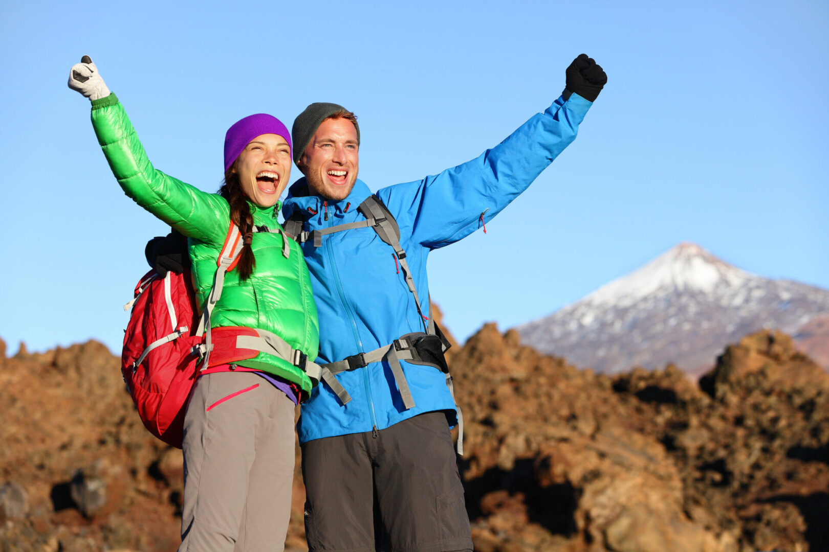 Couple in winter celebrating because they climbed a mountain using the energy from Energy Formula.